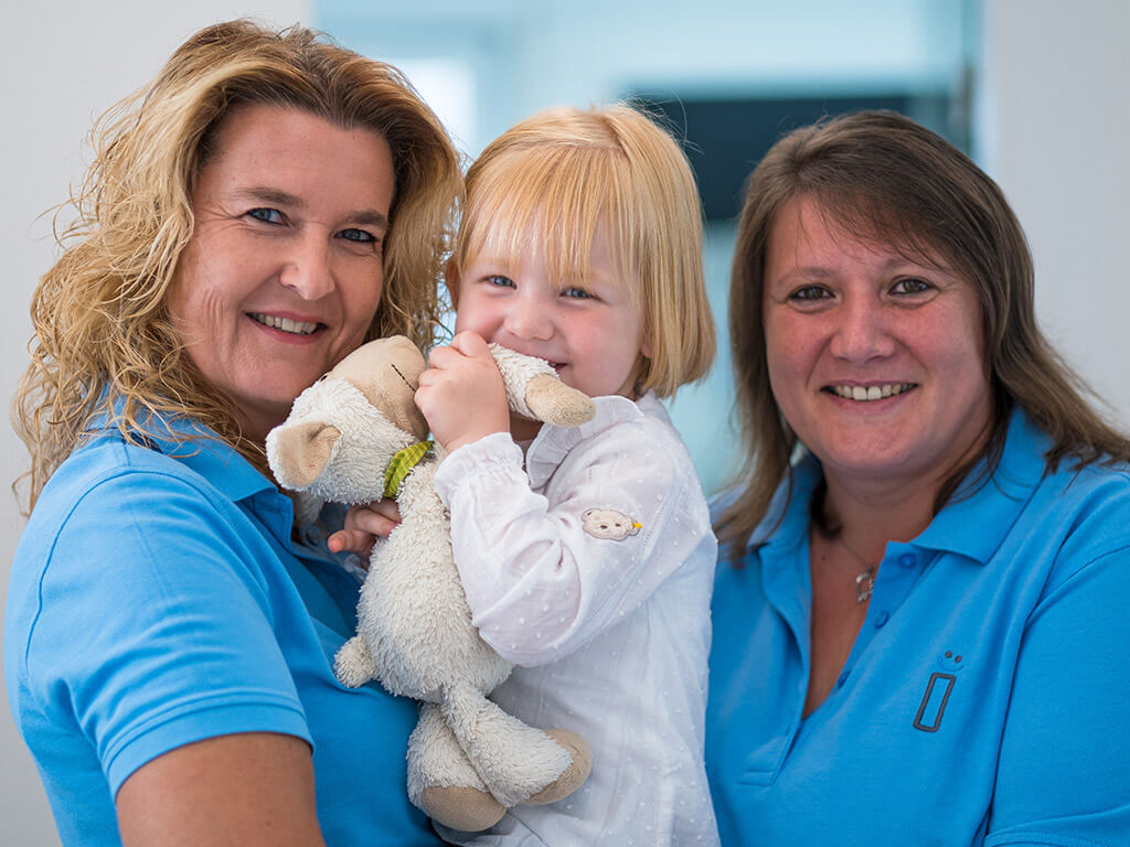 Impressionsbild Assistentinnen mit junger Patientin.